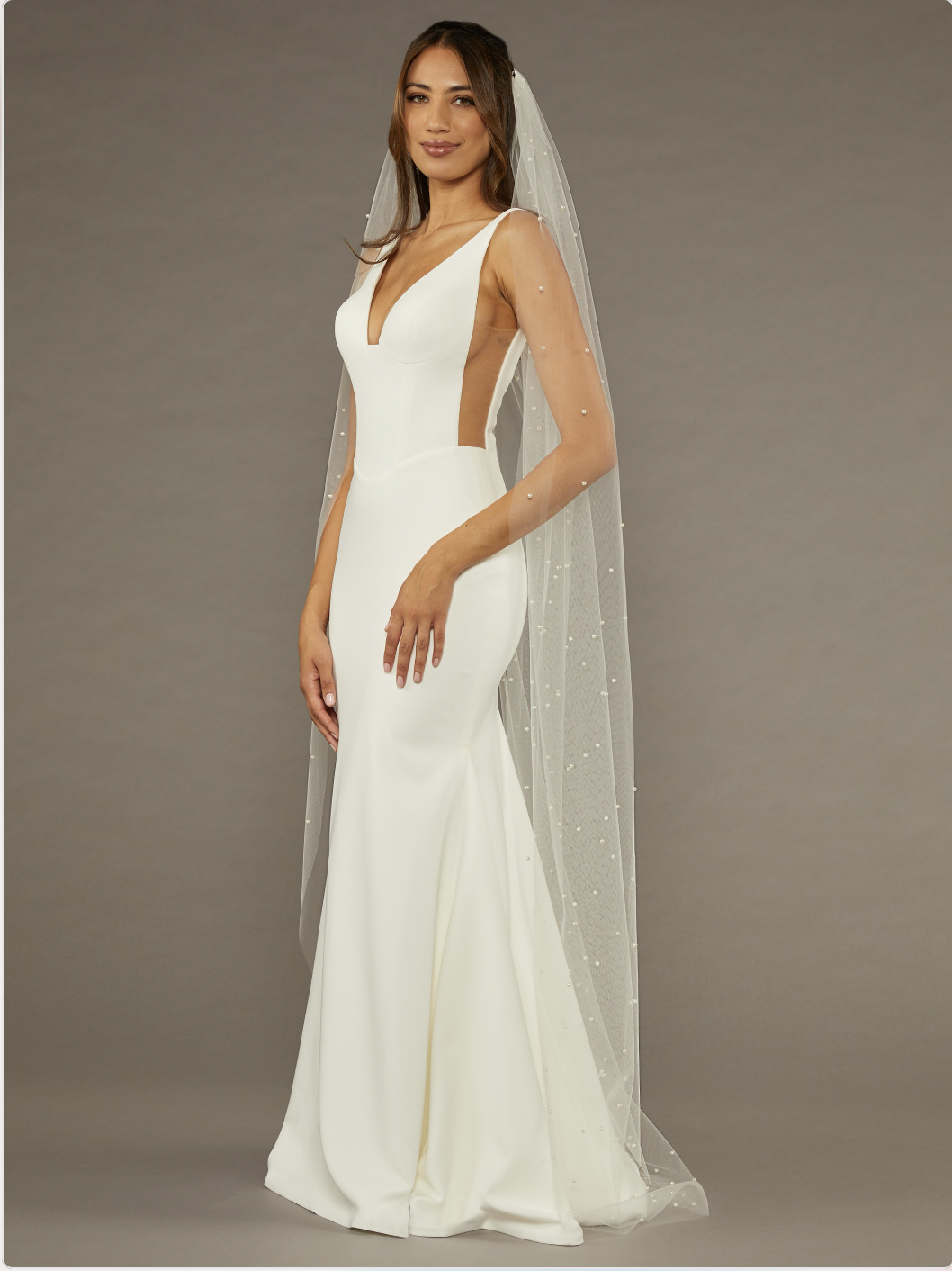 Sleek wedding dress paired with pear veil.